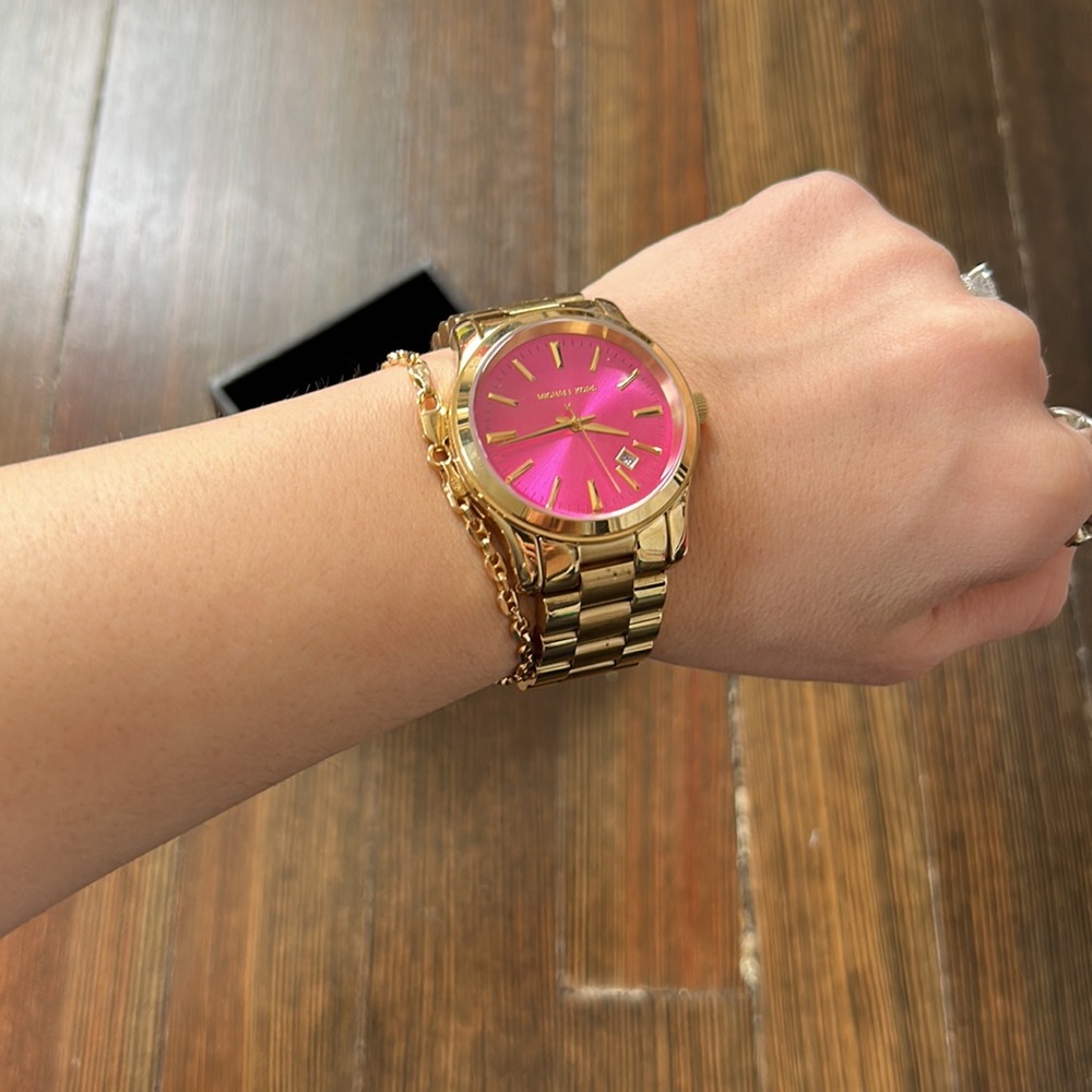 Gold Michael Kors watch with pink face